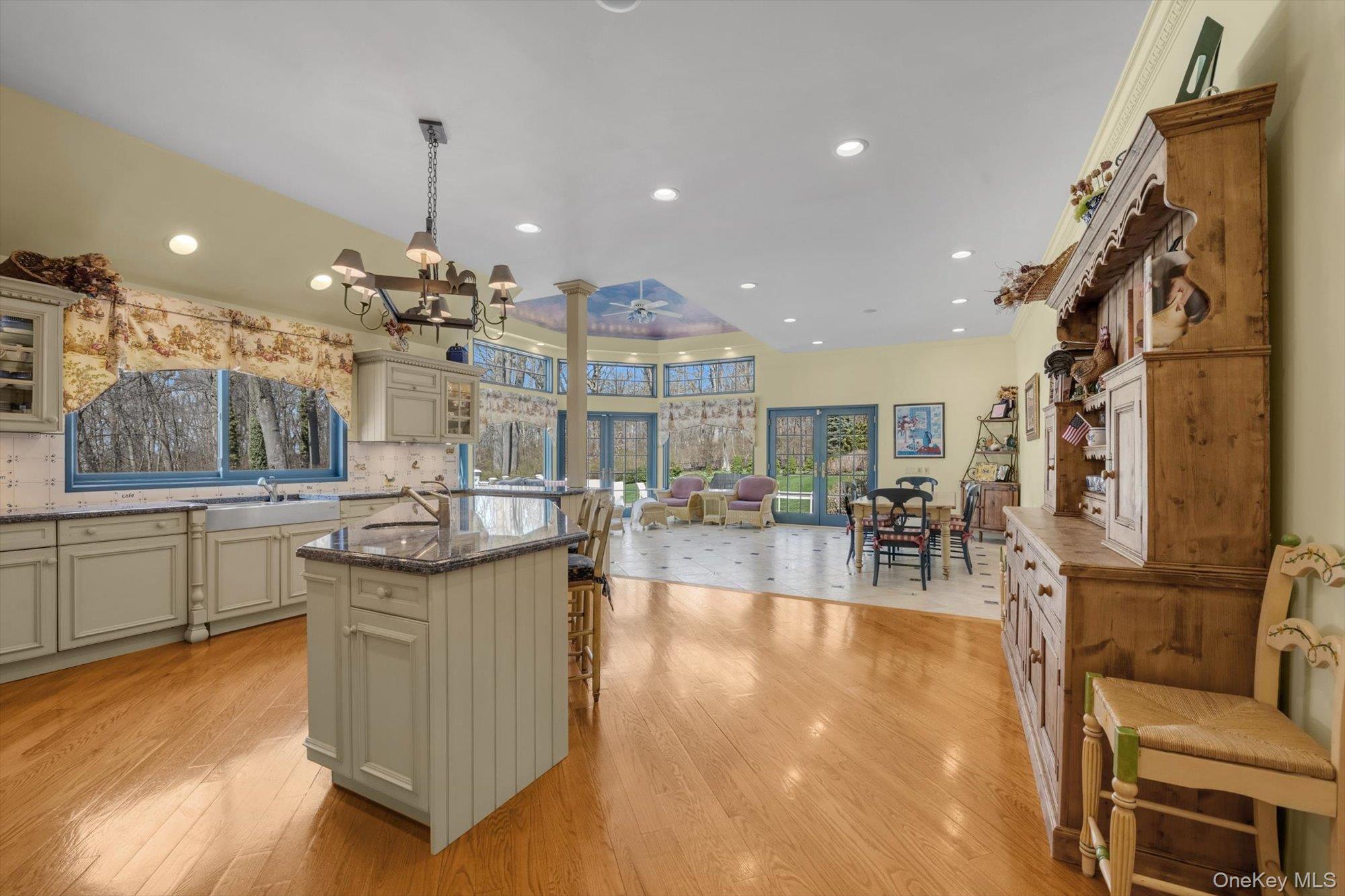 12 Overlook Court Locust Valley, NY 11560 - Photo 14 of 49 a living room with couches and kitchen view with wooden floor