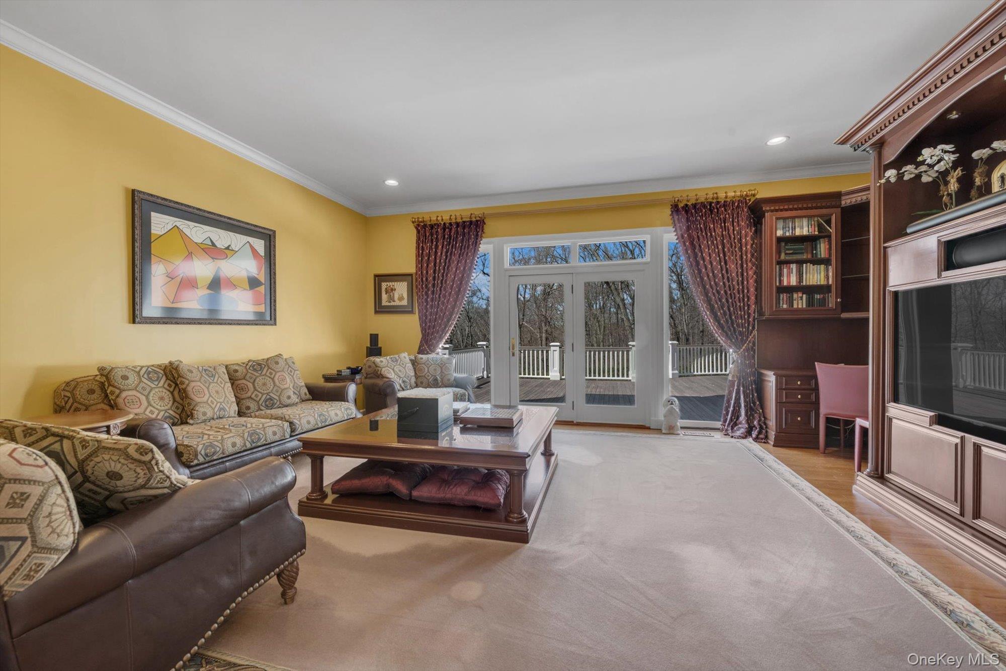 12 Overlook Court Locust Valley, NY 11560 - Photo 17 of 49 a living room with furniture and a flat screen tv