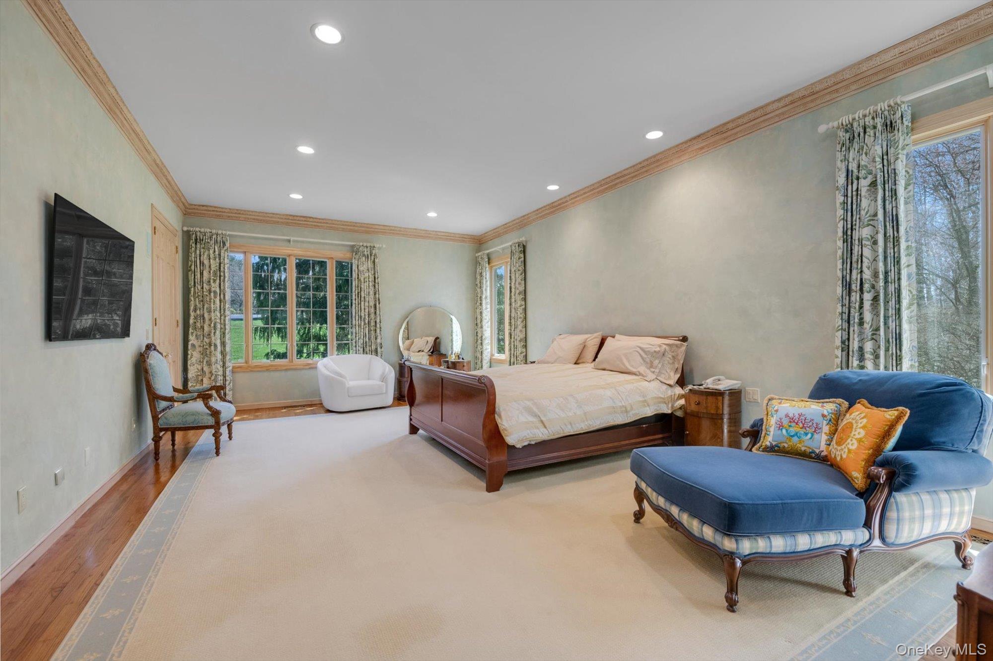 12 Overlook Court Locust Valley, NY 11560 - Photo 19 of 49 a spacious bedroom with a bed and a couch