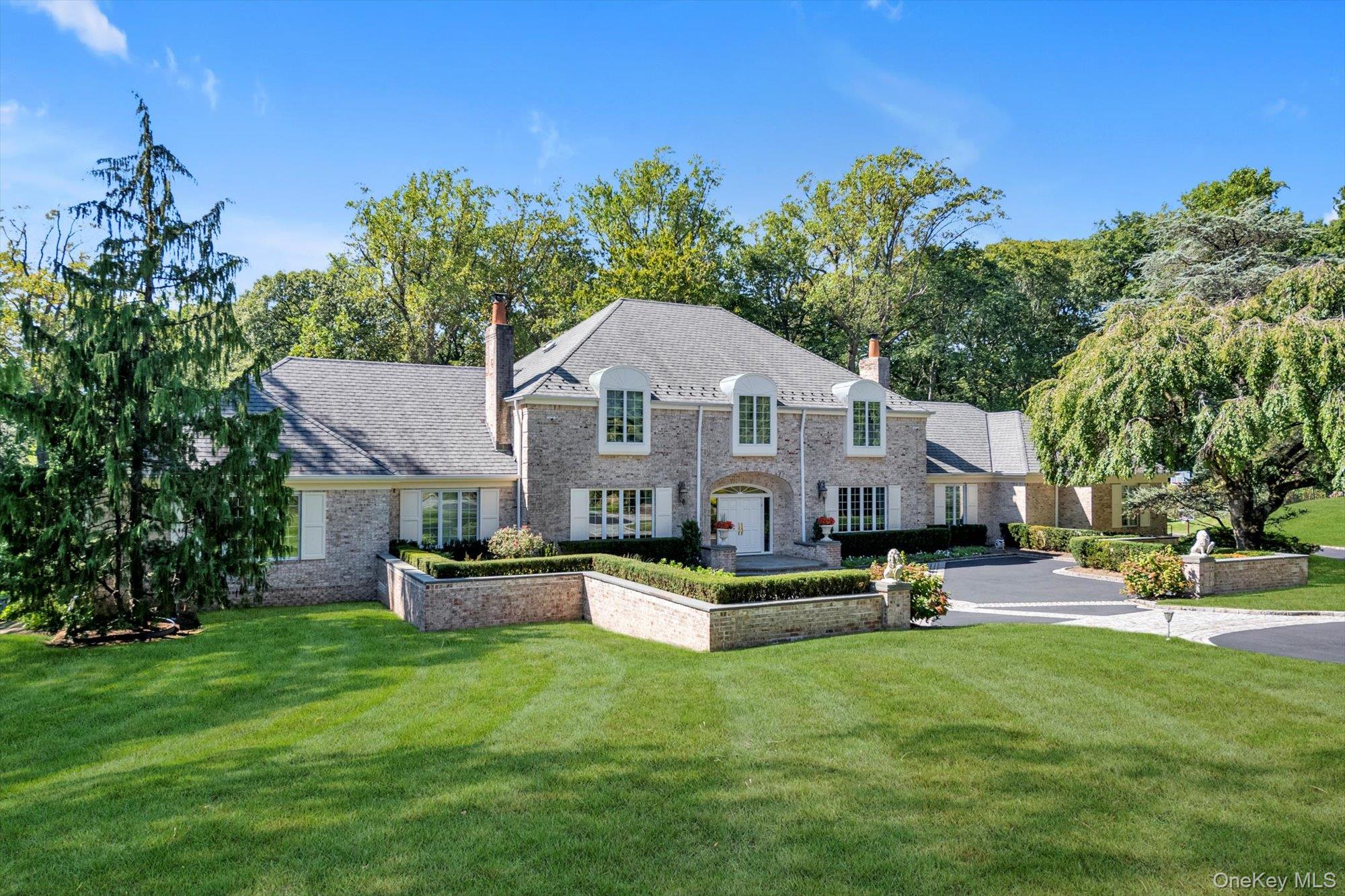 12 Overlook Court Locust Valley, NY 11560 - Photo 2 of 49 a front view of house with yard and outdoor seating