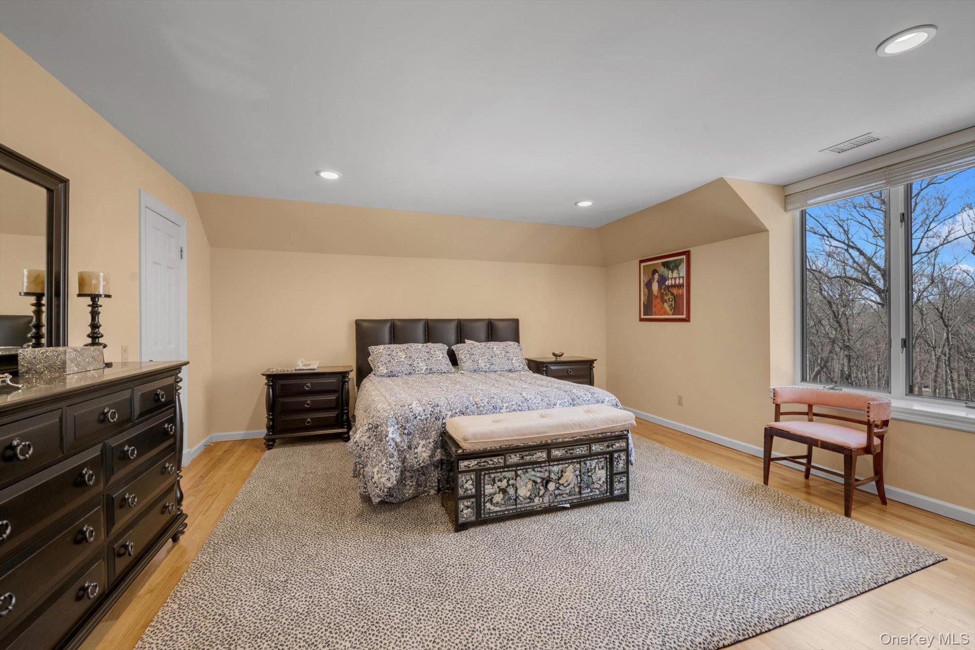12 Overlook Court Locust Valley, NY 11560 - Photo 29 of 49 a spacious bedroom with a bed and a dresser in it