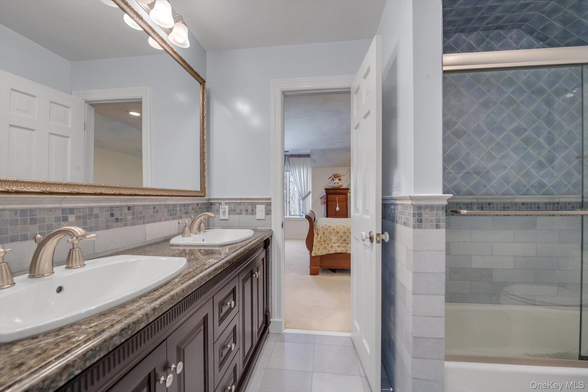 12 Overlook Court Locust Valley, NY 11560 - Photo 30 of 49 a bathroom with a sink and mirror