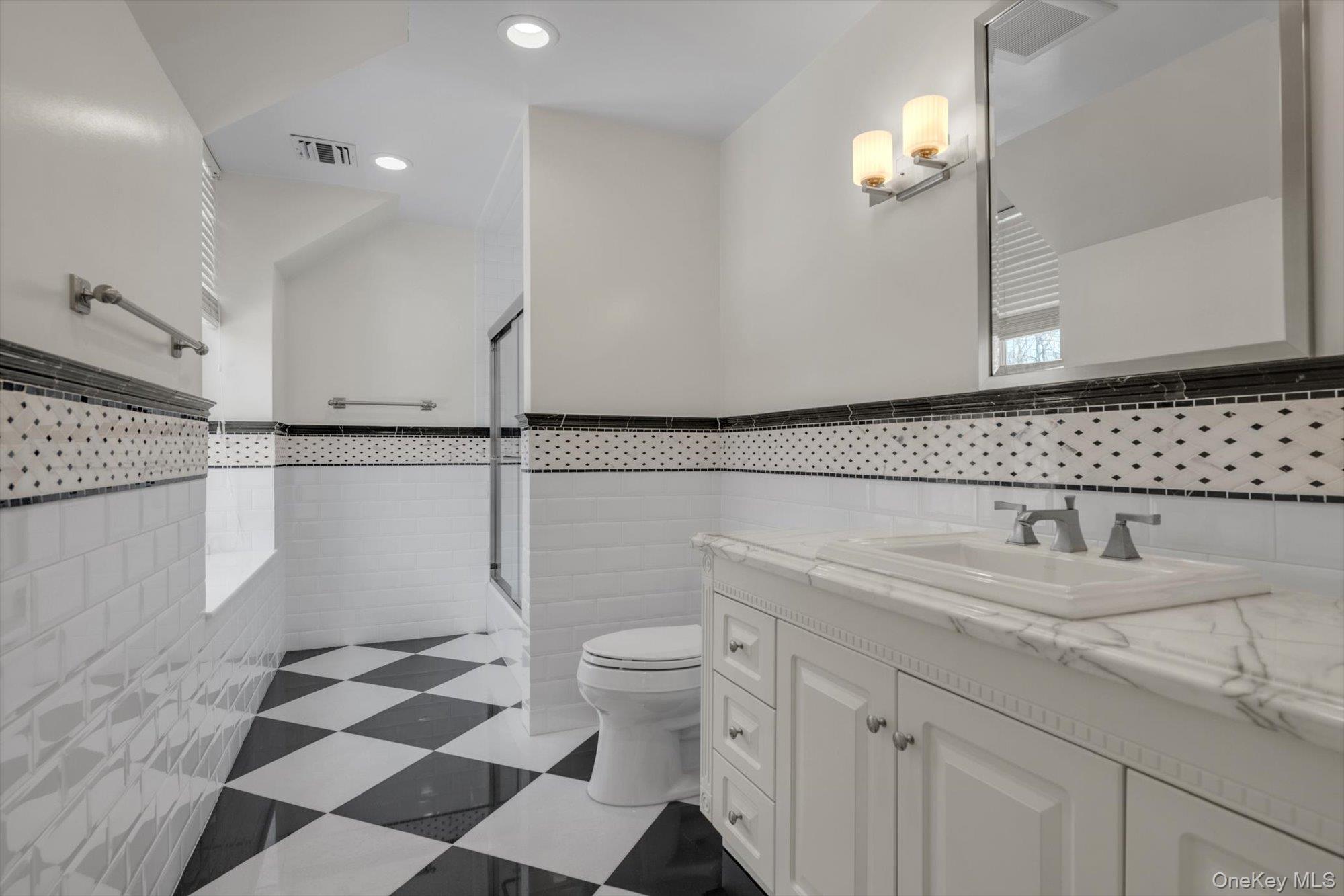 12 Overlook Court Locust Valley, NY 11560 - Photo 31 of 49 a bathroom with a sink a toilet and a mirror