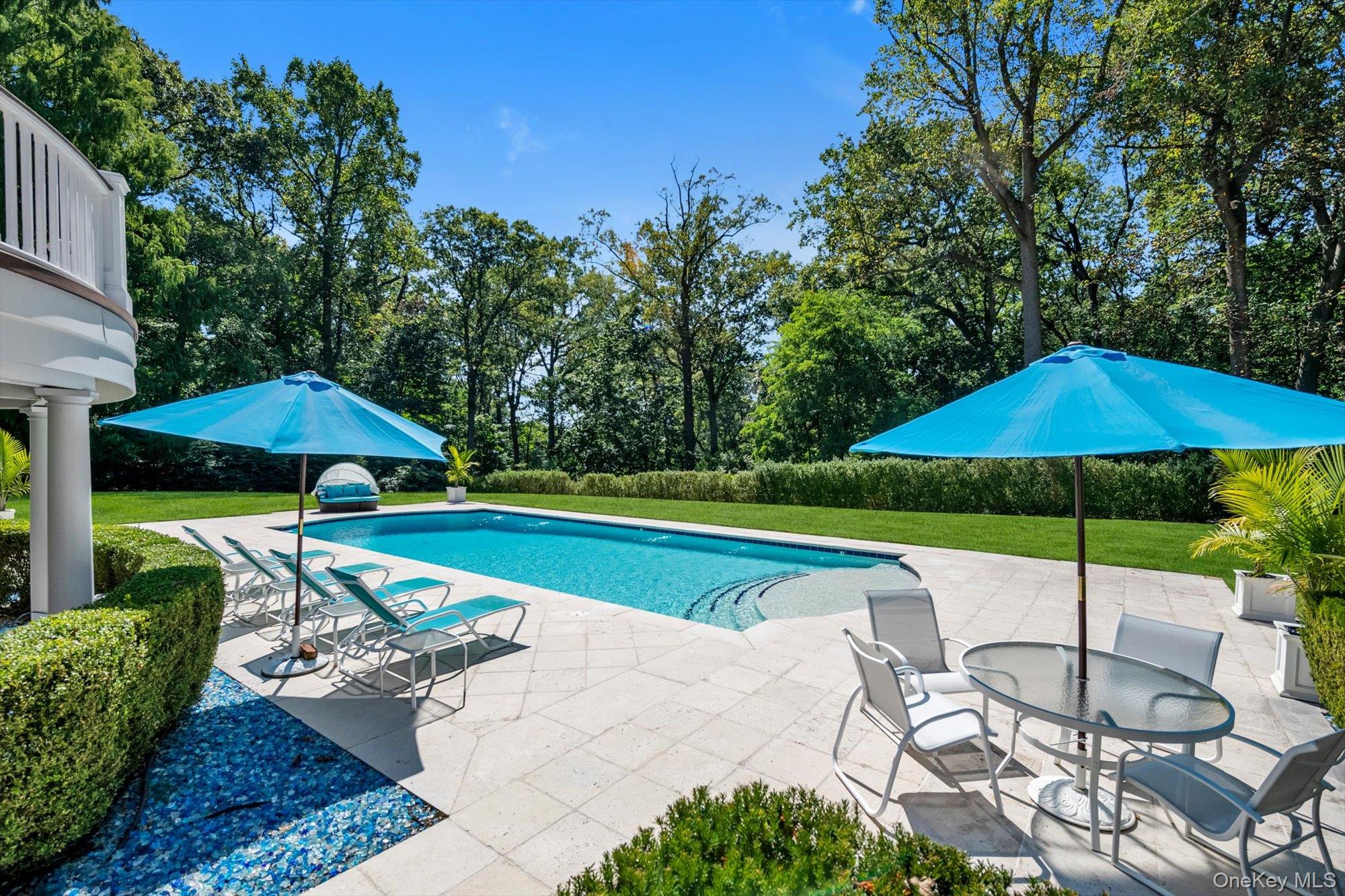 12 Overlook Court Locust Valley, NY 11560 - Photo 42 of 49 a view of a table and chairs under an umbrella