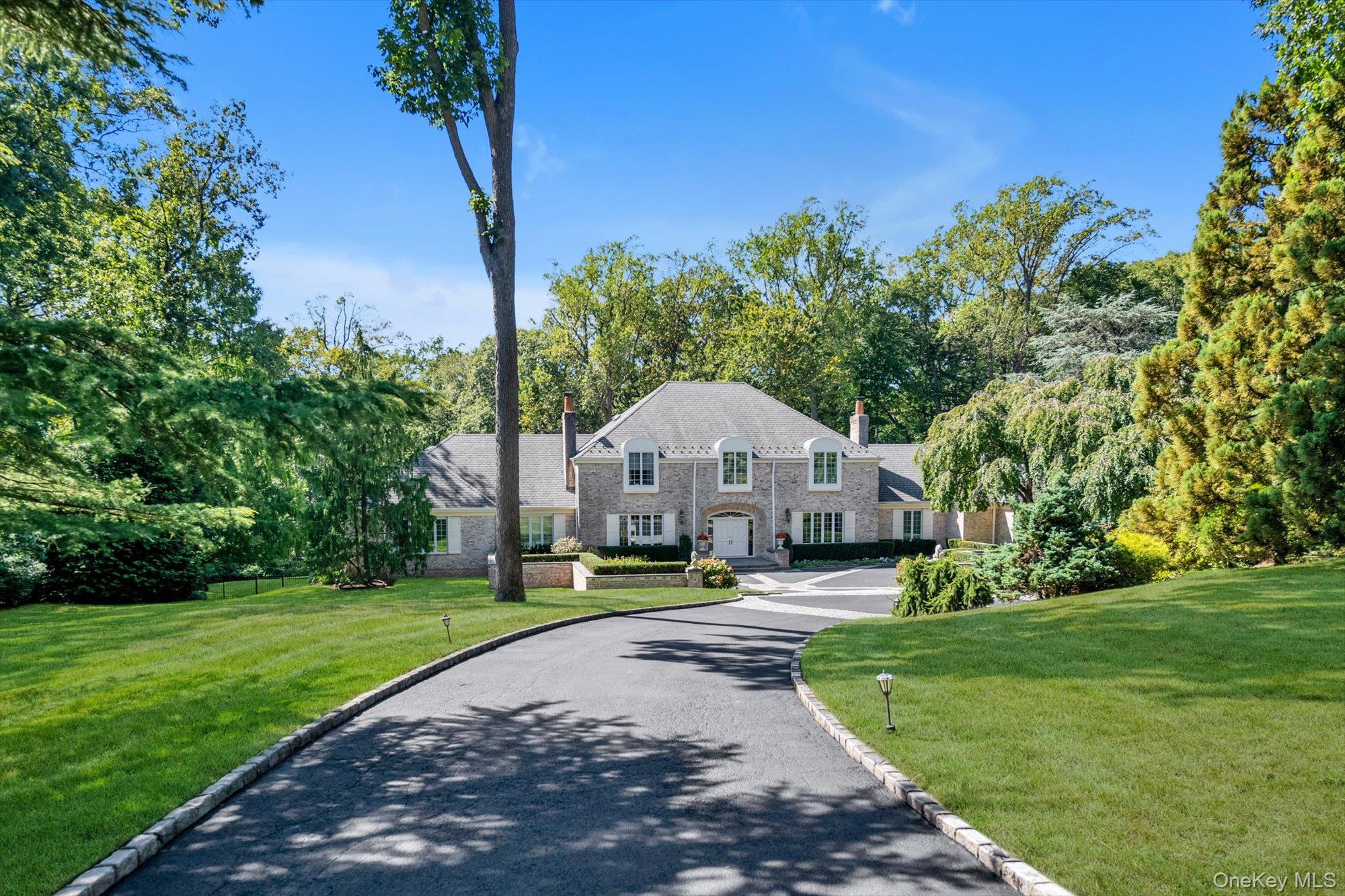 12 Overlook Court Locust Valley, NY 11560 - Photo 44 of 49 a front view of a house with garden