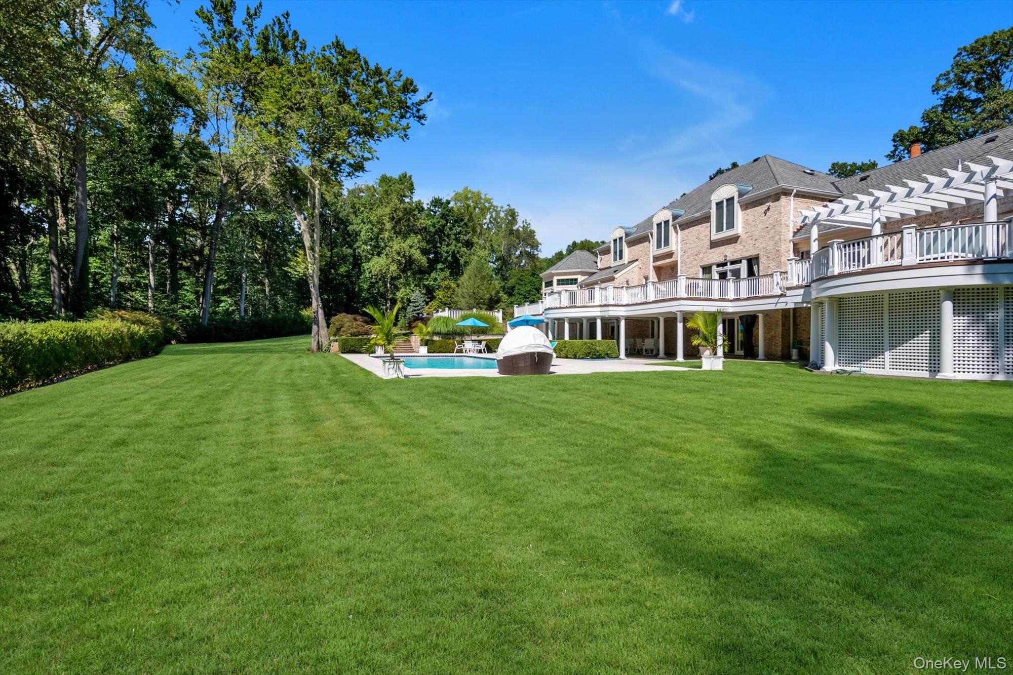 12 Overlook Court Locust Valley, NY 11560 - Photo 48 of 49 a front view of a house with a garden and trees