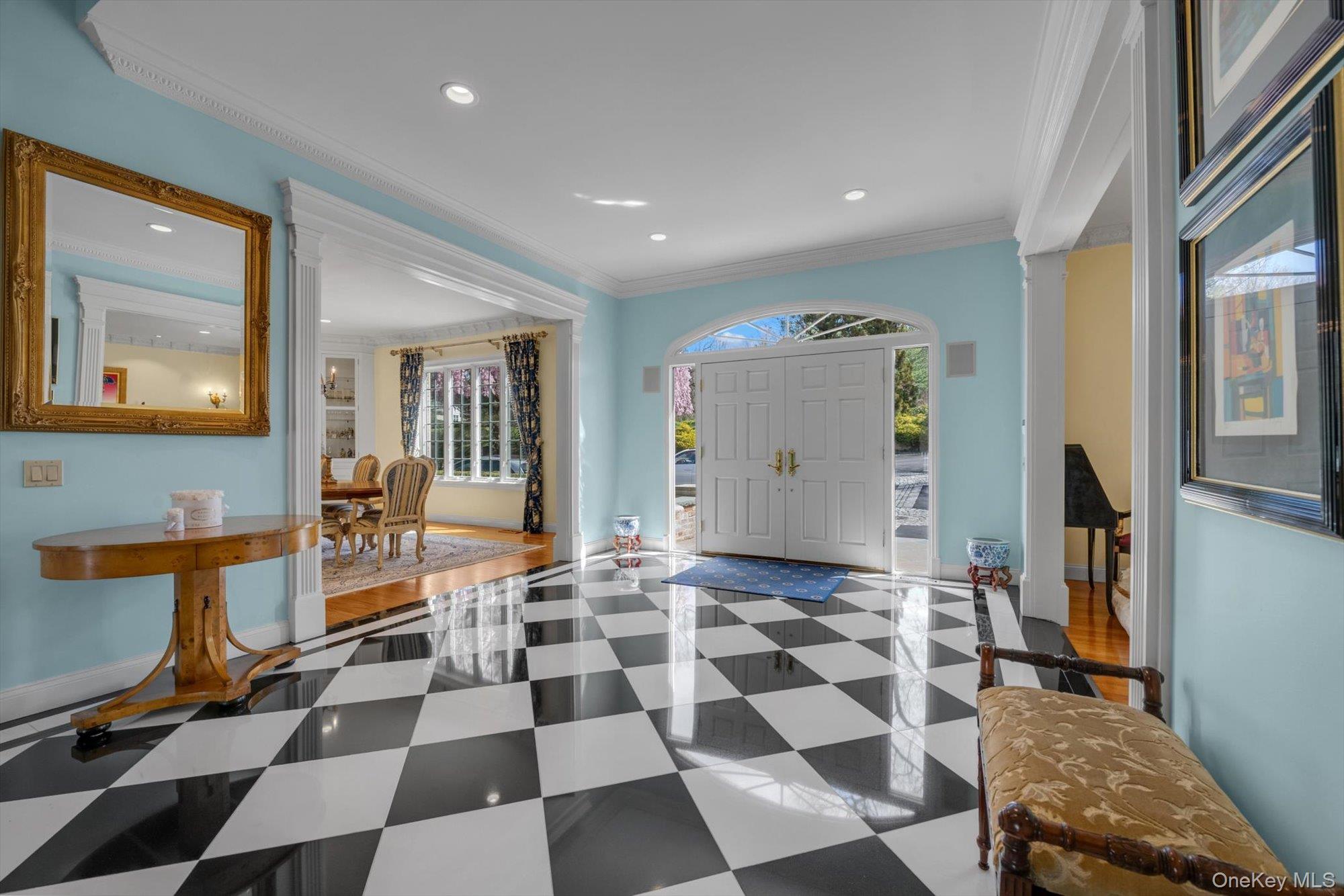 12 Overlook Court Locust Valley, NY 11560 - Photo 7 of 49 a room with a black white checkered floor with a gaming machine and dining chairs