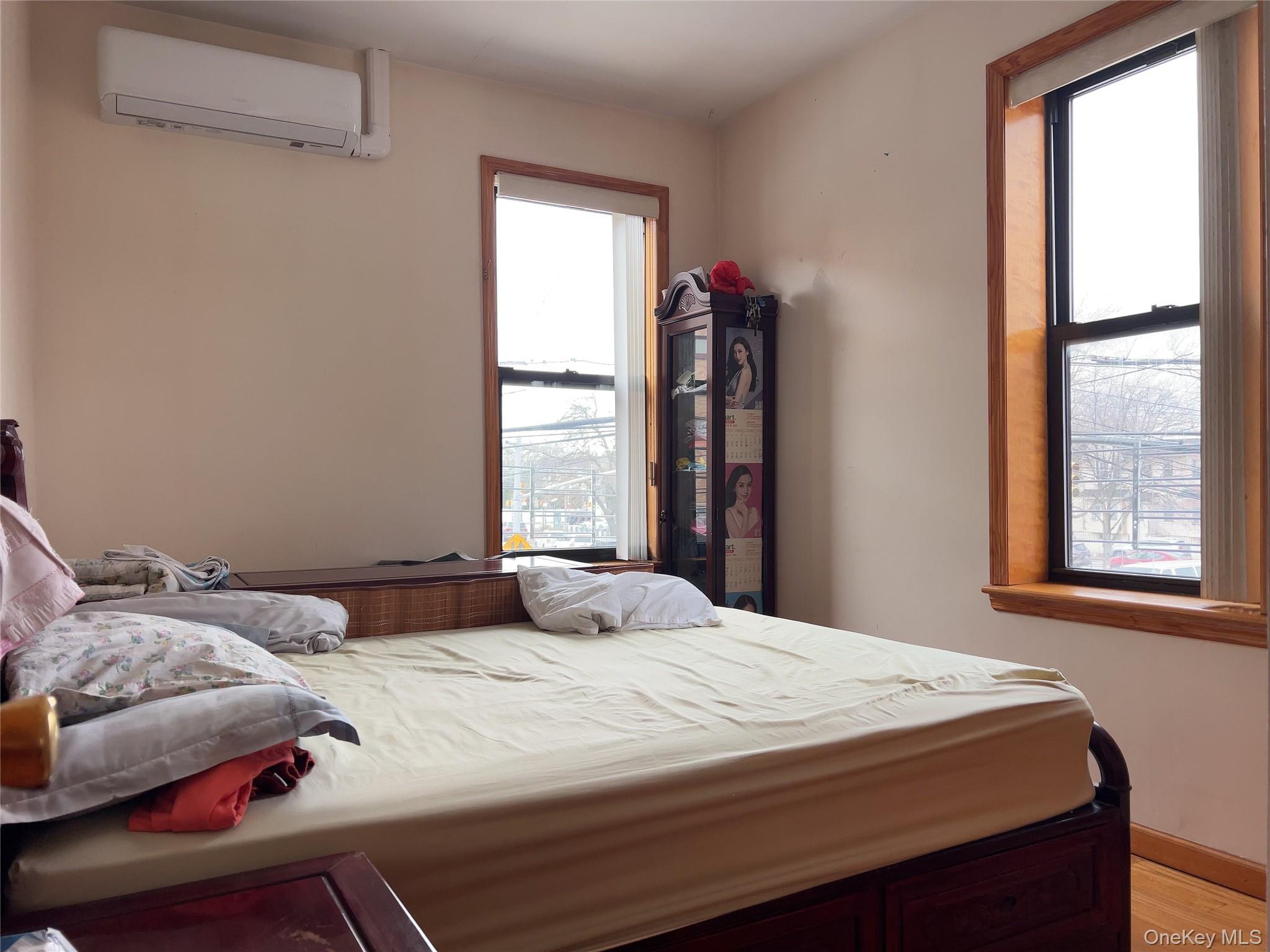 32-01 Junction Boulevard, Unit 4 Queens, NY 11369 - Photo 10 of 14 a bedroom with a bed and a window