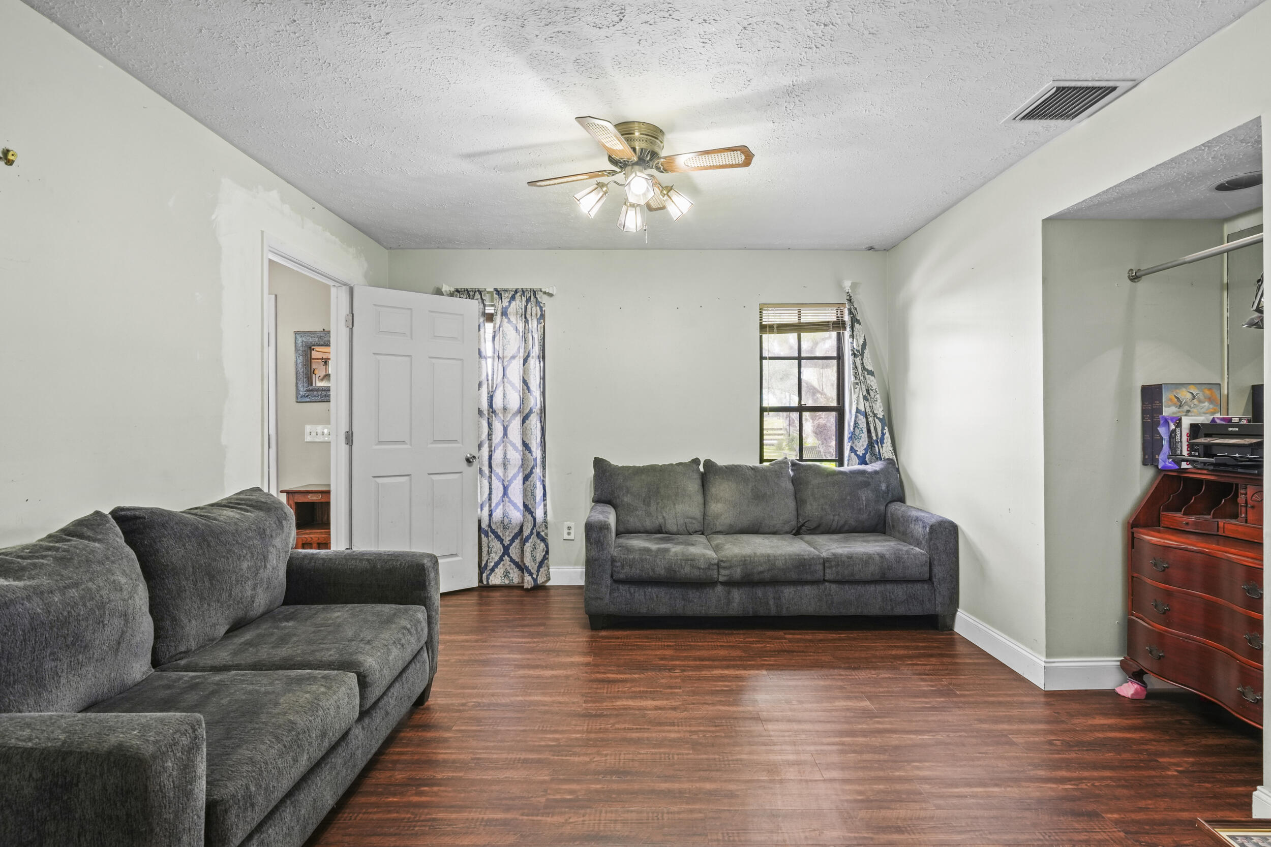 4170 McCarty Road Fort Pierce, FL 34945 - Photo 26 of 57 a living room with furniture and a wooden floor