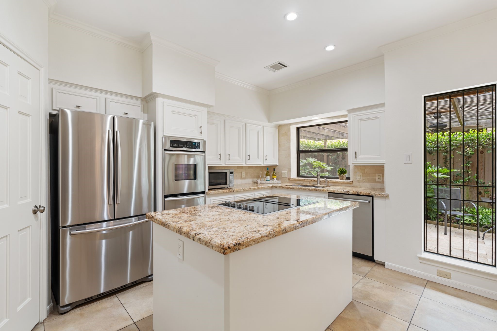 7416 Kelving Street Houston, TX 77030 - Photo 10 of 35 a kitchen with a refrigerator a stove a sink and a refrigerator