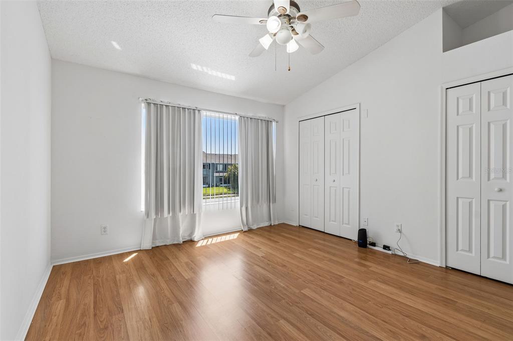 382 Countryside Key Boulevard Oldsmar, FL 34677 - Photo 36 of 58 an empty room with wooden floor fan and windows