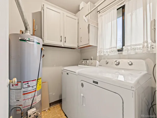 a kitchen with granite countertop a sink cabinets and wooden floor