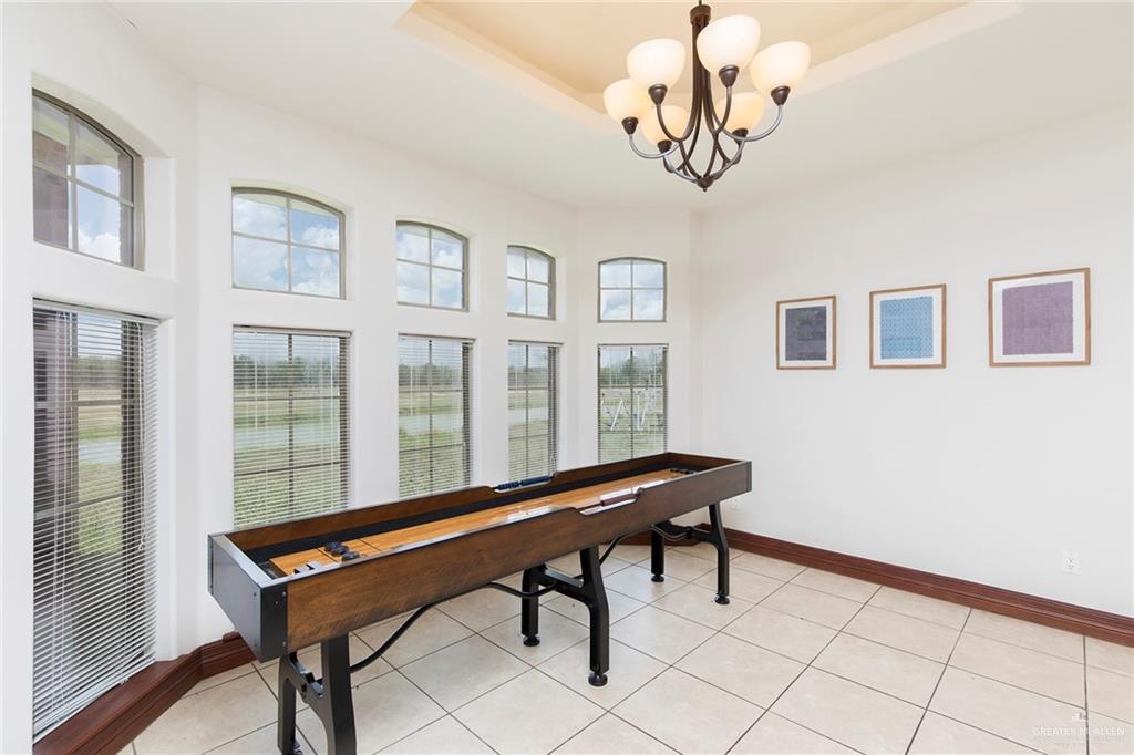 1213 Rhett Drive Pharr, TX 78577 - Photo 9 of 19 Elegant dining area with oversized windows and beautiful backyard views.