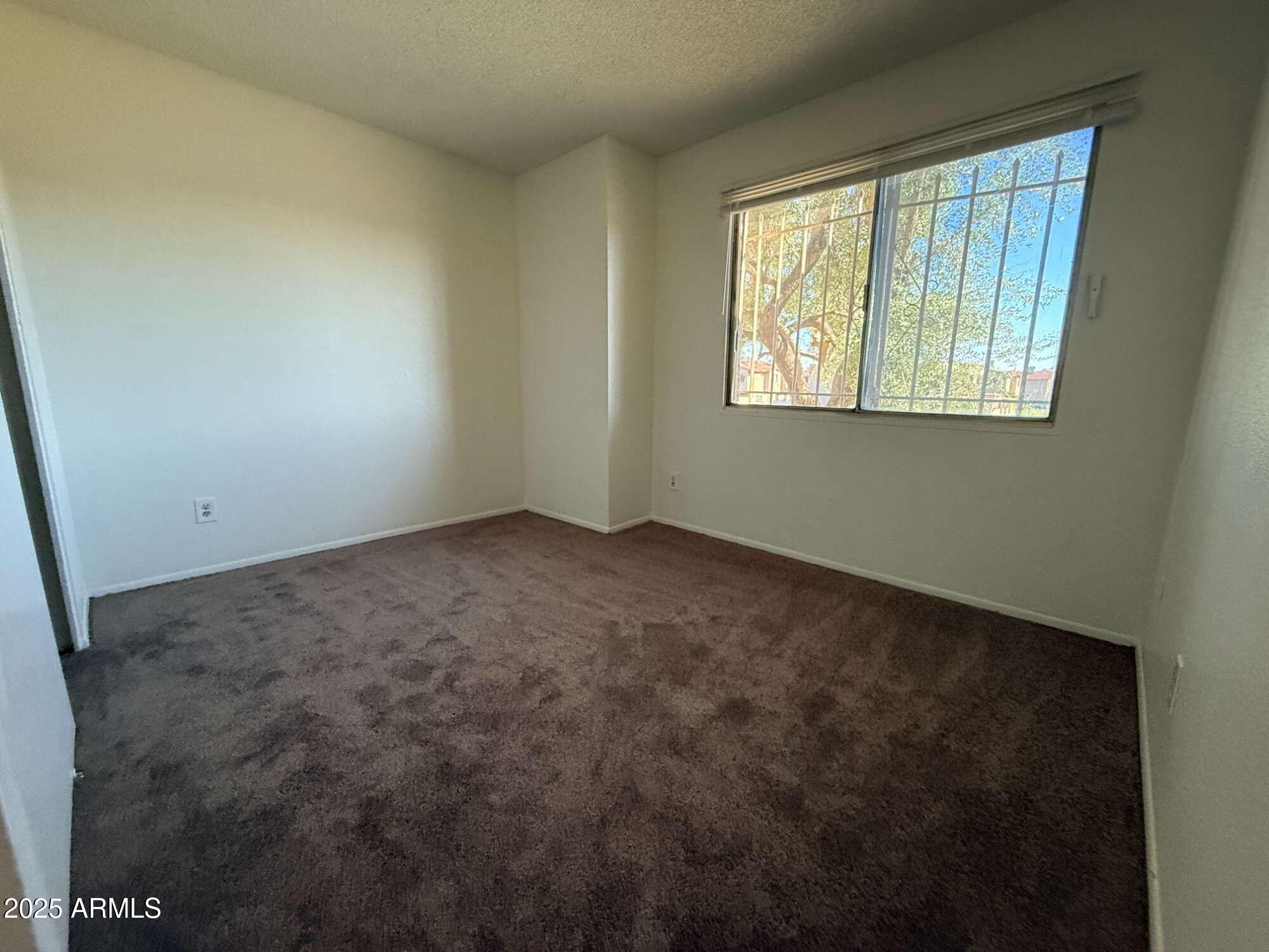 3947 West Wonderview Road Phoenix, AZ 85019 - Photo 12 of 16 an empty room with a window