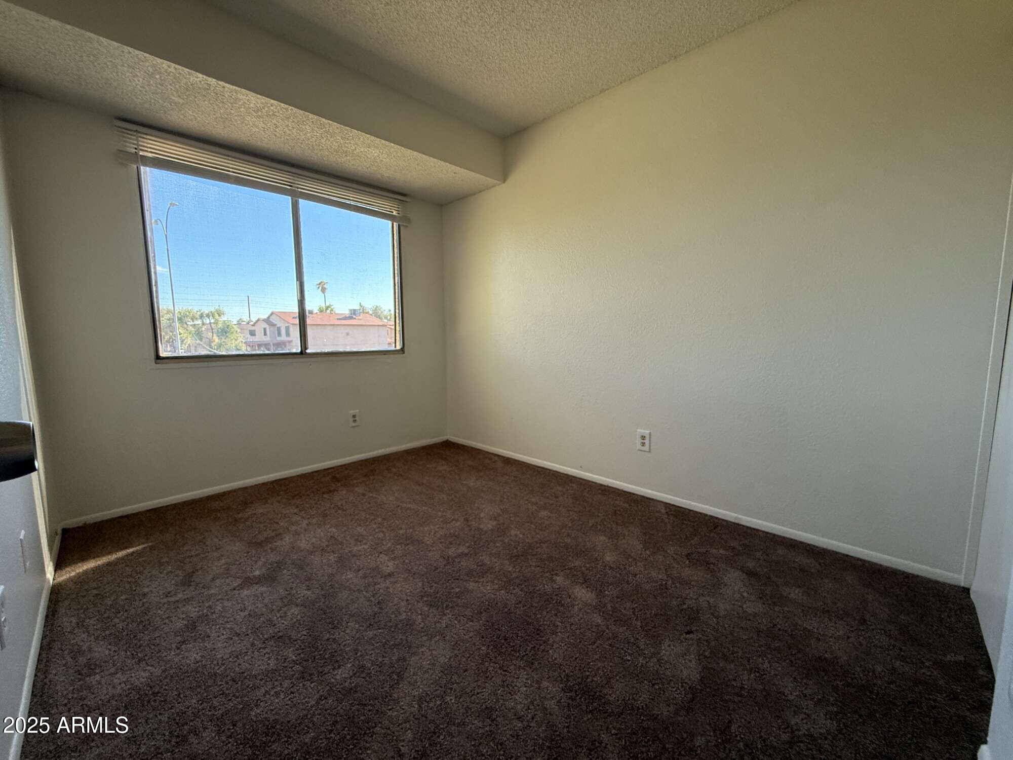 3947 West Wonderview Road Phoenix, AZ 85019 - Photo 14 of 16 an empty room with windows