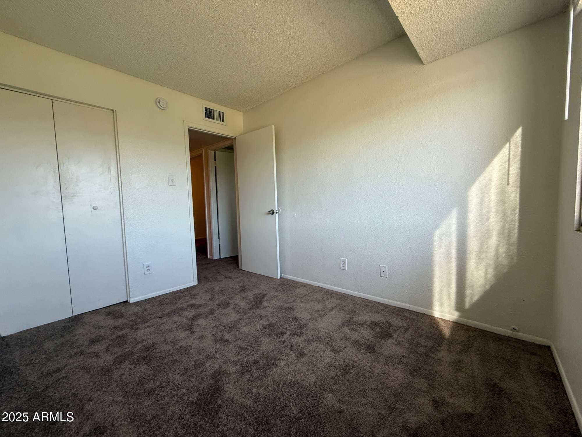 3947 West Wonderview Road Phoenix, AZ 85019 - Photo 15 of 16 a view of an empty room and window
