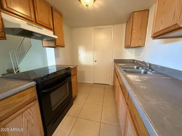 a view of a kitchen with a sink and cabinets
