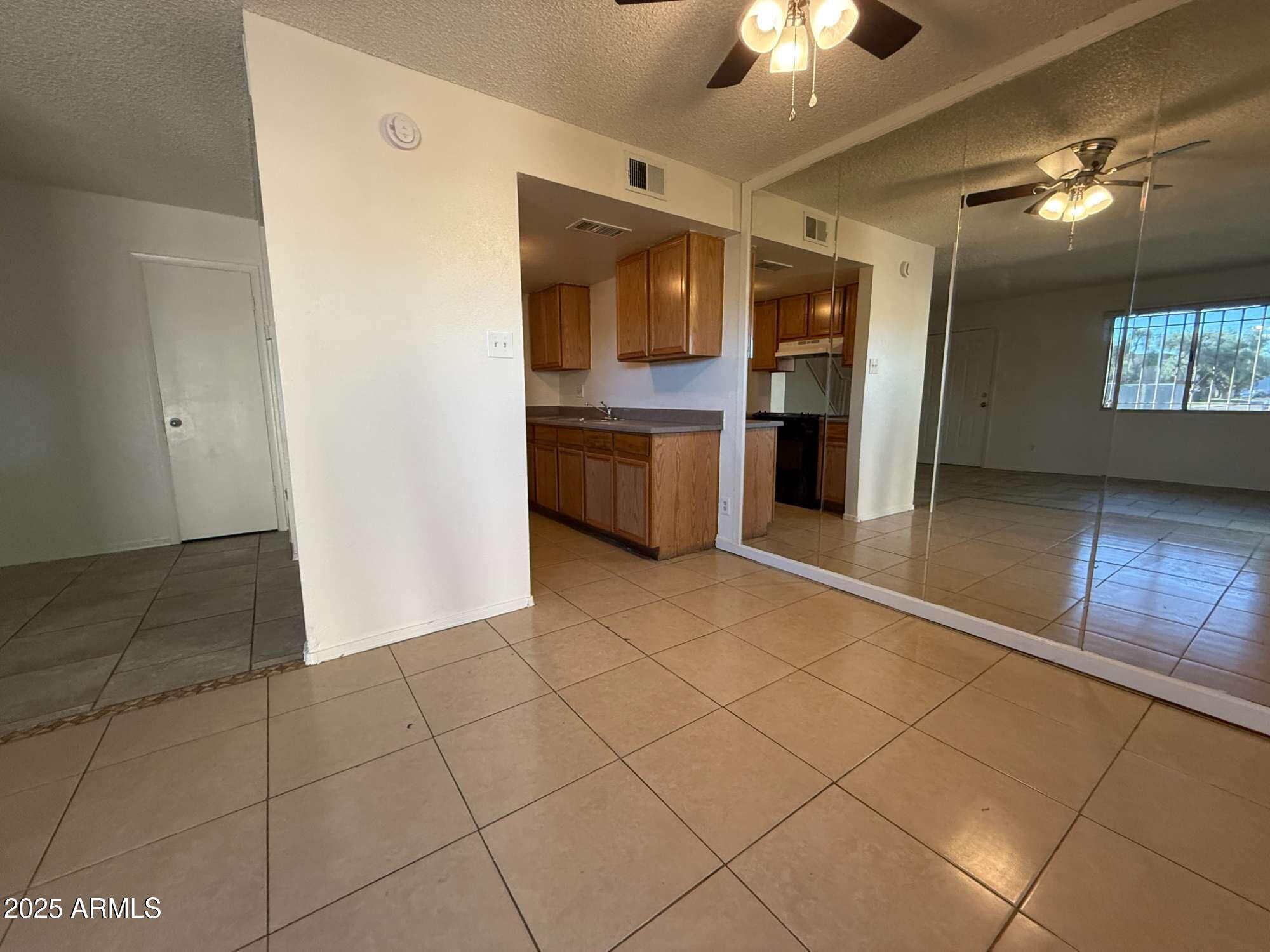 3947 West Wonderview Road Phoenix, AZ 85019 - Photo 5 of 16 a view of a kitchen with a sink and cabinets