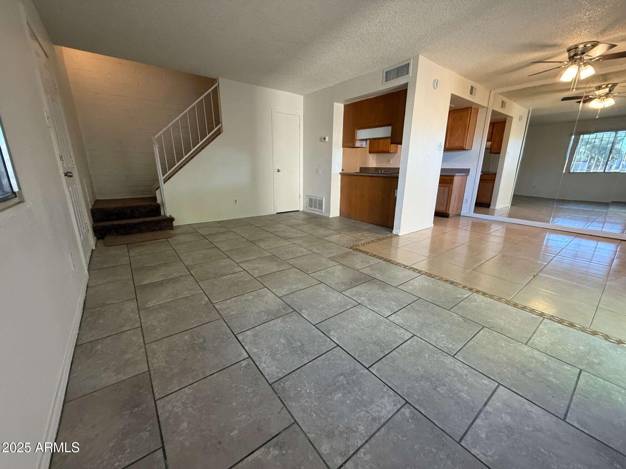 3947 West Wonderview Road Phoenix, AZ 85019 - Photo 6 of 16 a view of an empty room with a fireplace