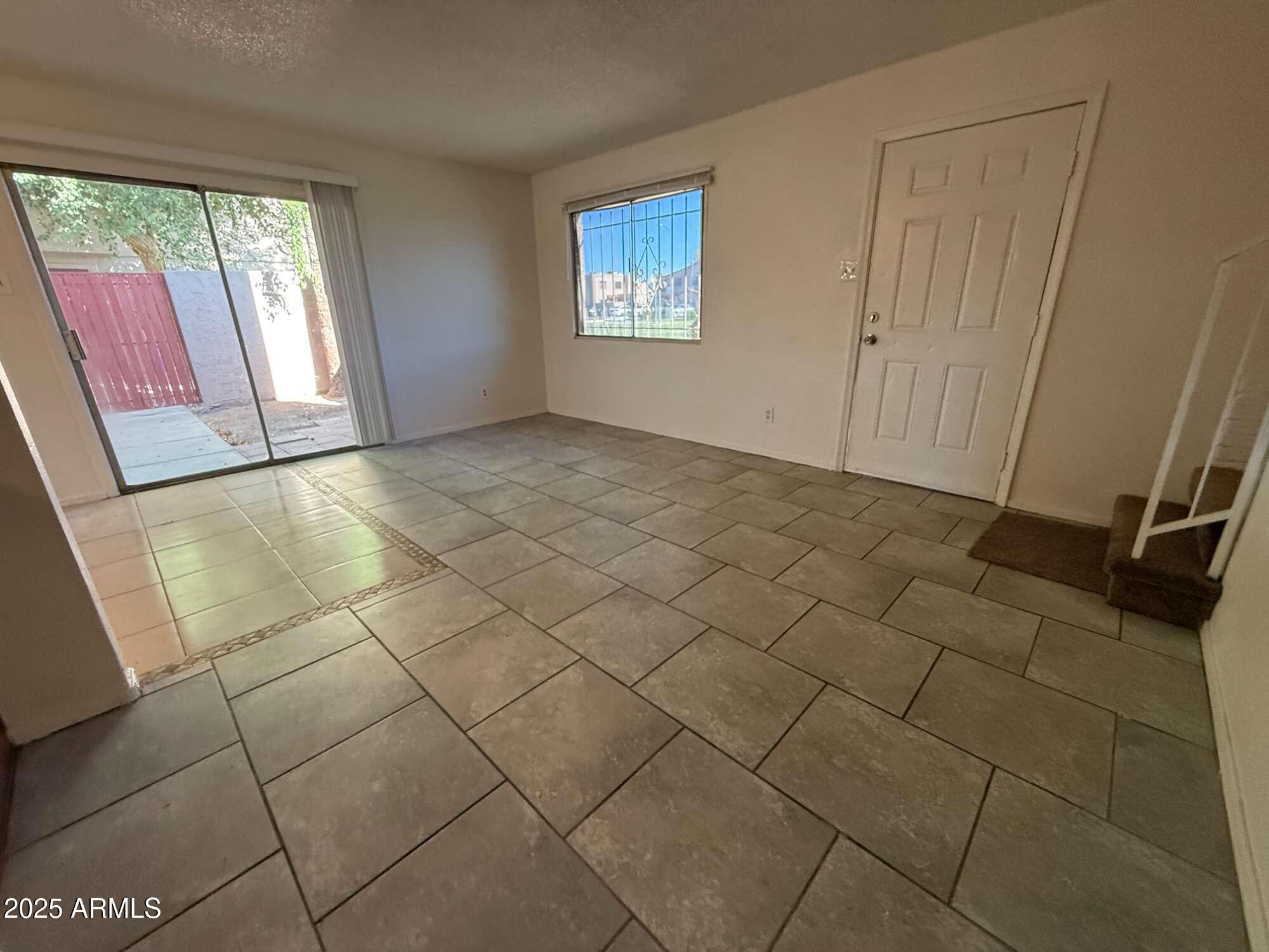 3947 West Wonderview Road Phoenix, AZ 85019 - Photo 7 of 16 a view of an empty room and window