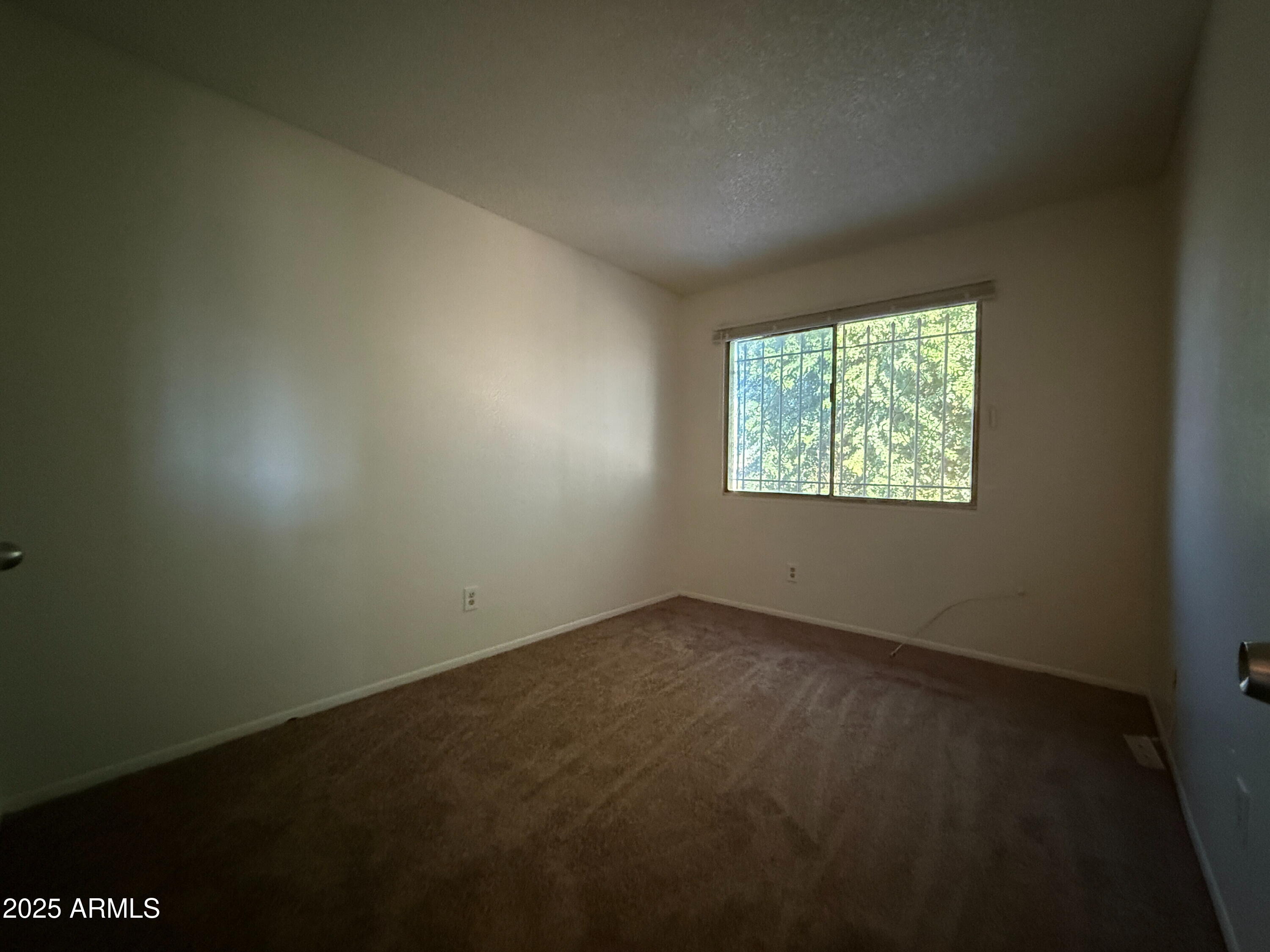 3947 West Wonderview Road Phoenix, AZ 85019 - Photo 10 of 16 an empty room with windows