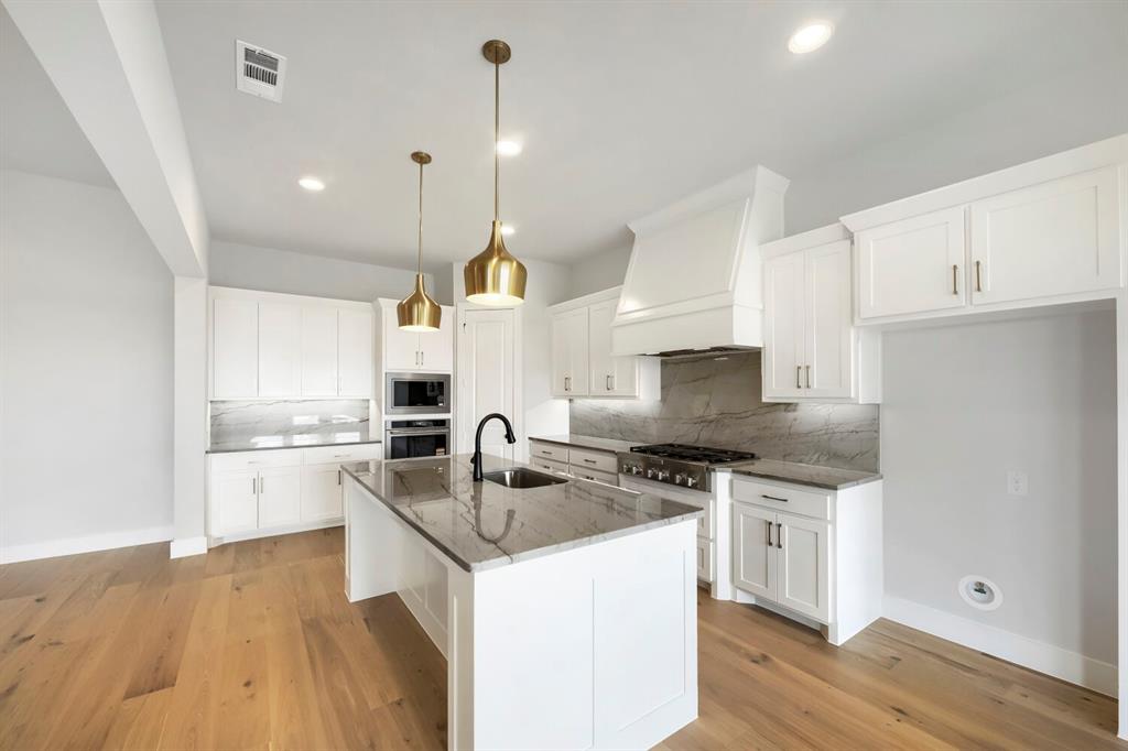 799 Mandrake Road Haslet, TX 76052 - Photo 7 of 27 a kitchen with a sink a stove a refrigerator and a cabinets