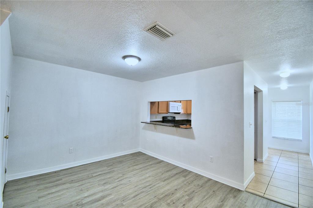 5359 River Rock Road Lakeland, FL 33809 - Photo 12 of 51 a room with wooden floor and a flat screen tv