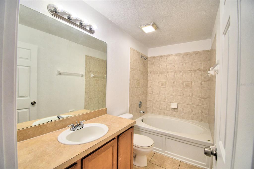 5359 River Rock Road Lakeland, FL 33809 - Photo 29 of 51 a bathroom with a sink a toilet and shower