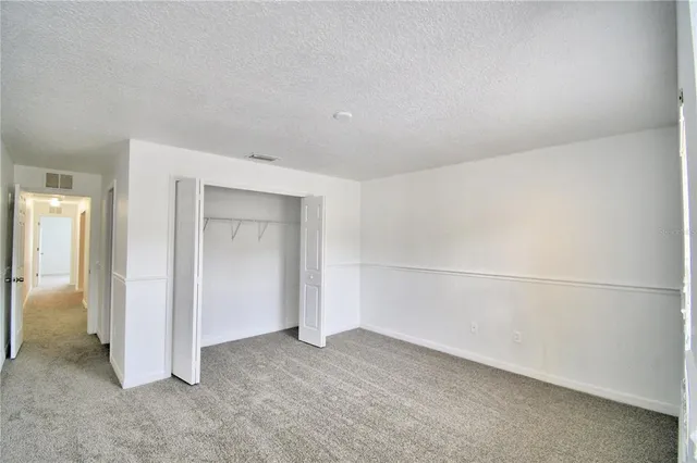 a bathroom with a bathtub shower sink vanity mirror and toilet
