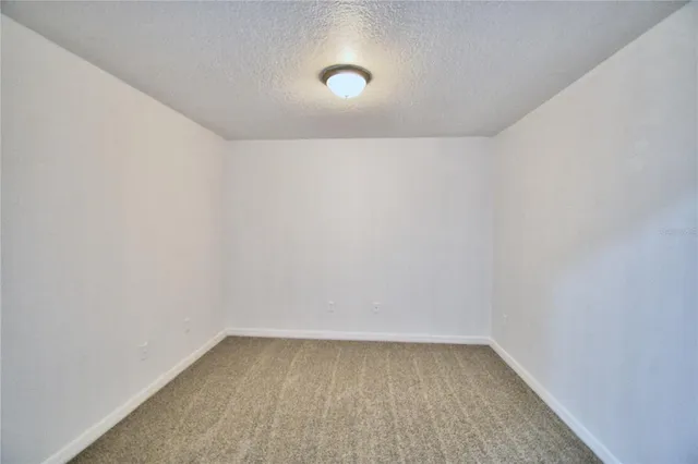 a front view of a house with a yard and potted plants