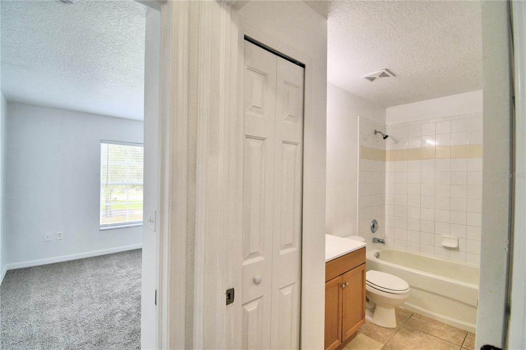 5359 River Rock Road Lakeland, FL 33809 - Photo 39 of 51 a bathroom with a granite countertop toilet a sink and shower