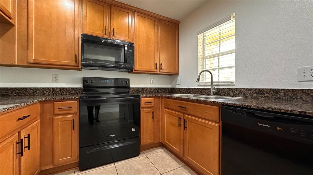 5359 River Rock Road Lakeland, FL 33809 - Photo 10 of 51 a kitchen with stainless steel appliances granite countertop a stove a sink and a microwave