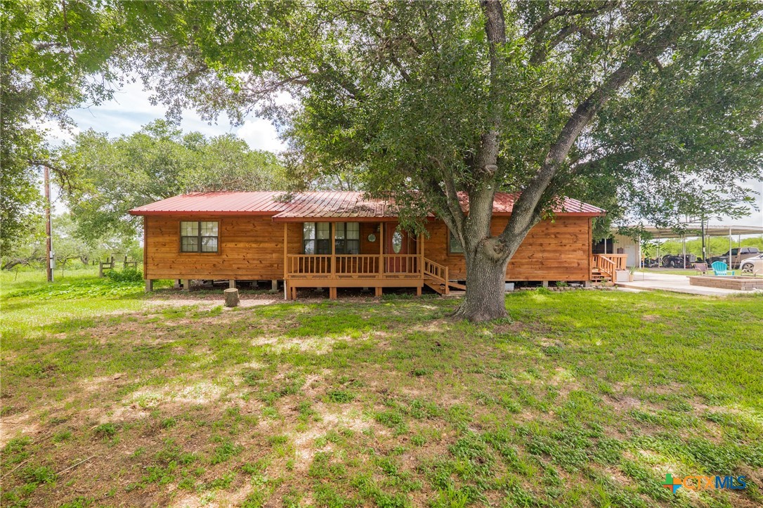 a view of a house with a backyard