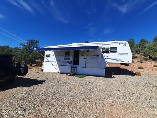 a view of a house with wooden fence