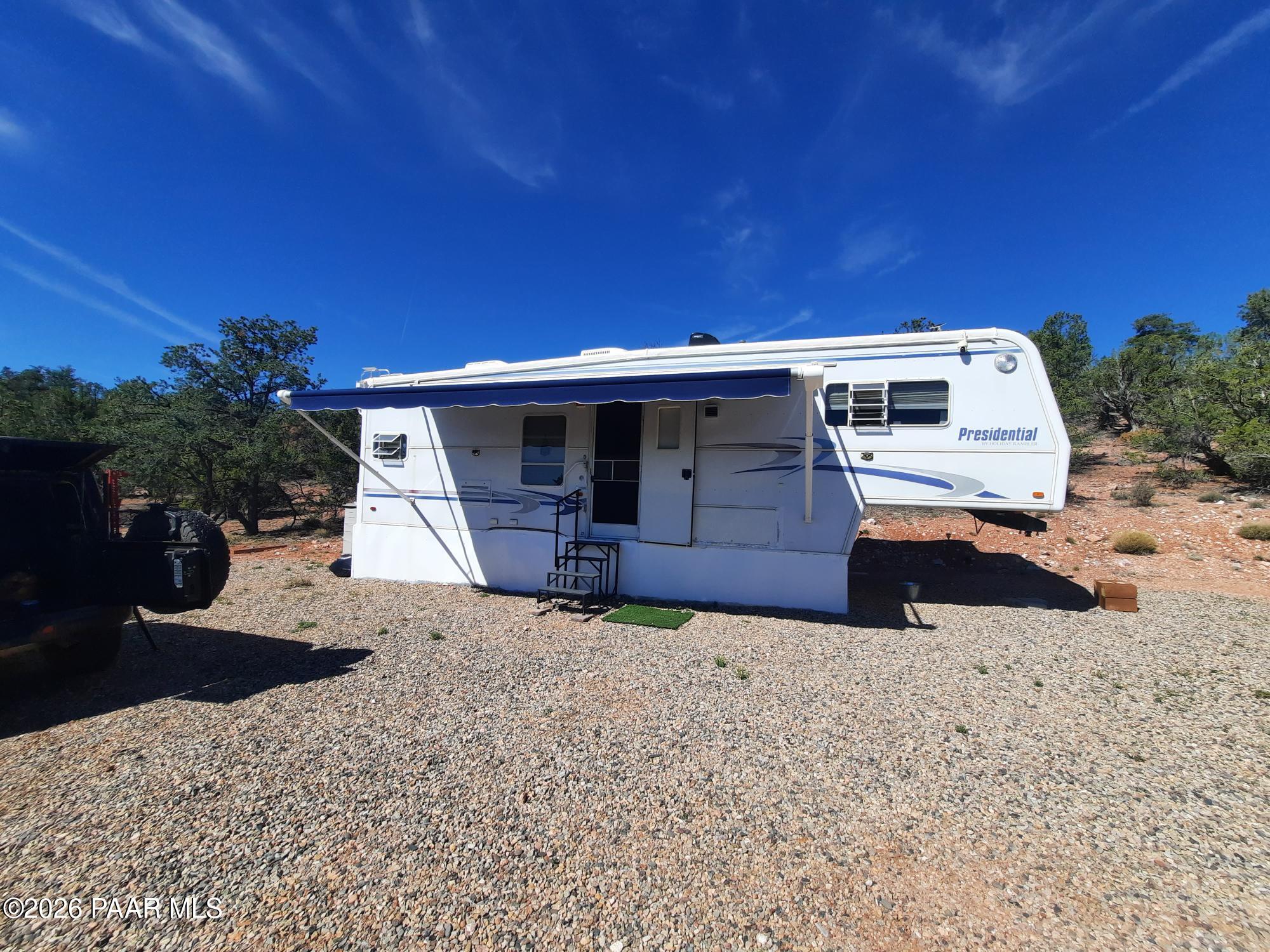 261 East W Titan Ranch Road Seligman, AZ 86337 - Photo 1 of 24 a view of a house with wooden fence