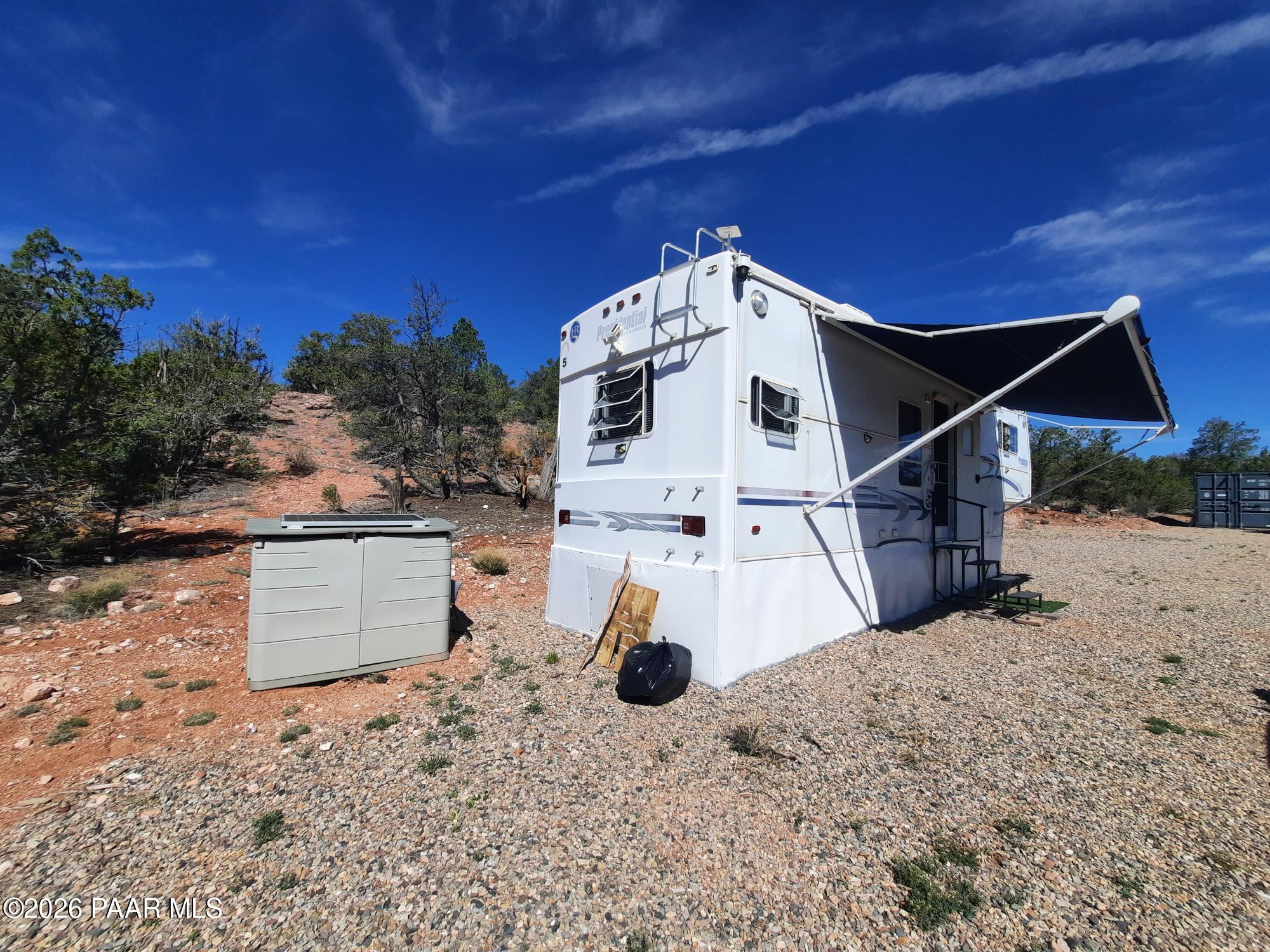 261 East W Titan Ranch Road Seligman, AZ 86337 - Photo 11 of 24 a view of a roof with a tree in the background