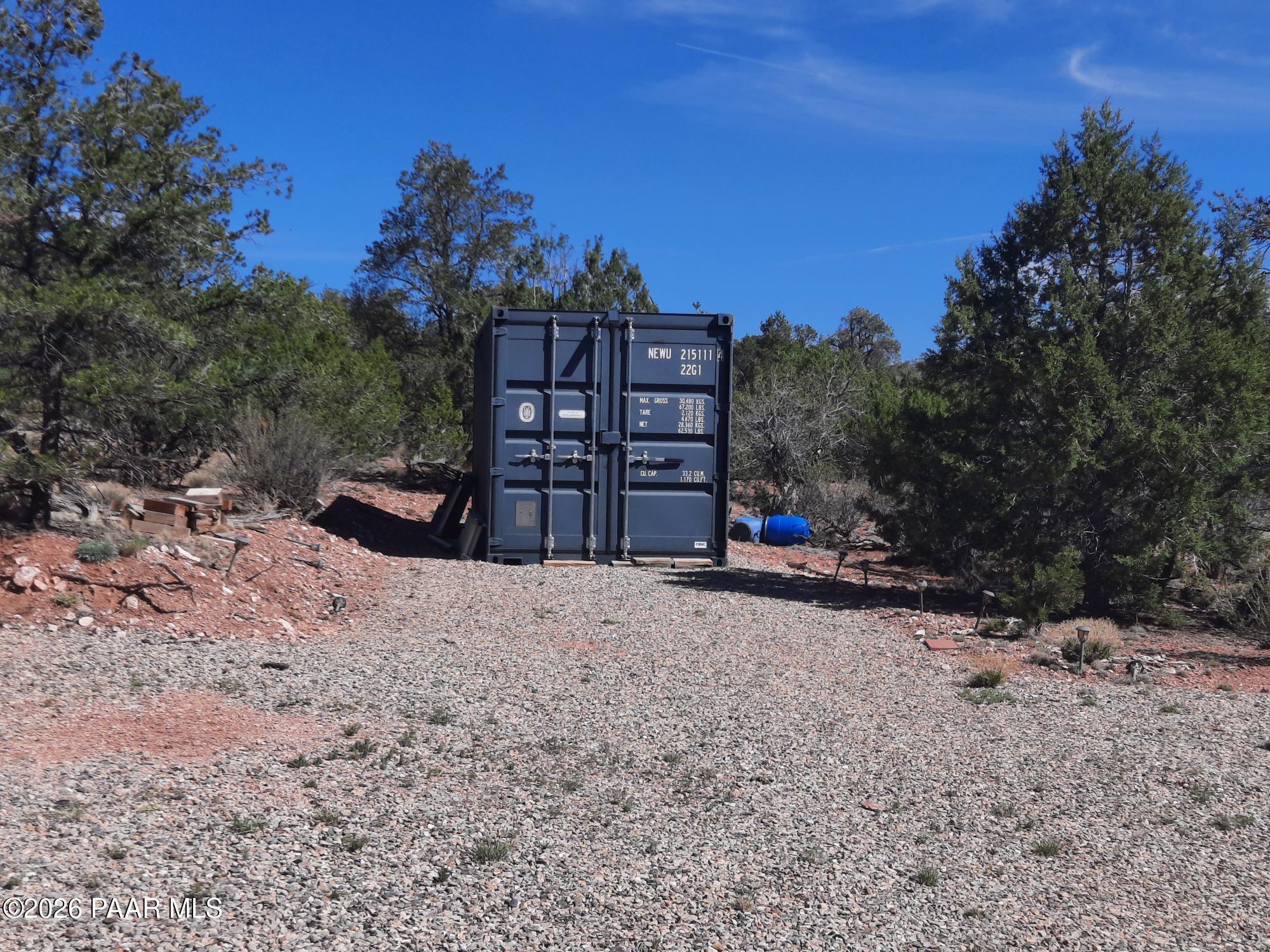 261 East W Titan Ranch Road Seligman, AZ 86337 - Photo 13 of 24 a view of a wooden bench under a large tree