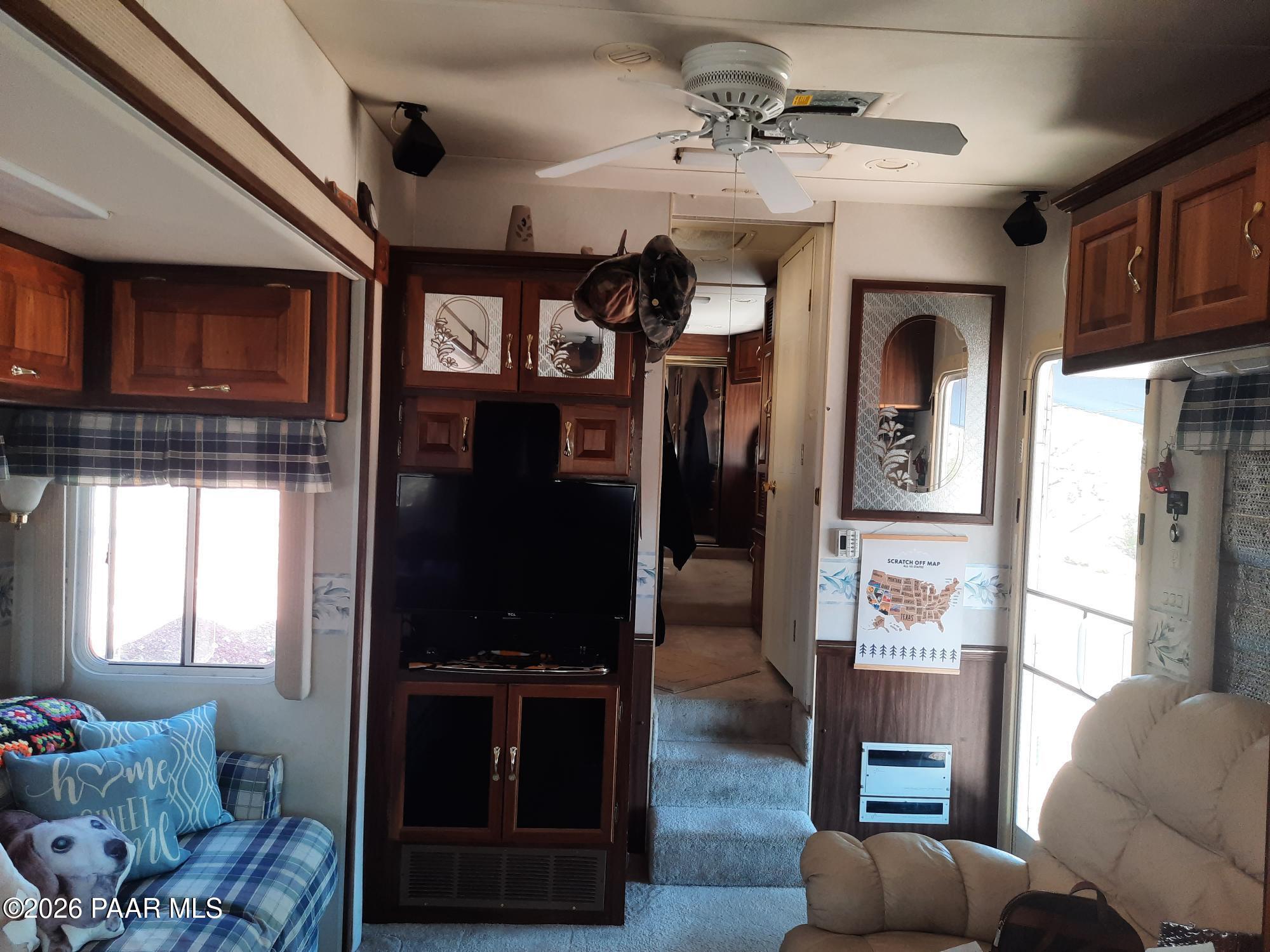 261 East W Titan Ranch Road Seligman, AZ 86337 - Photo 6 of 24 a living room with furniture a ceiling fan and a window