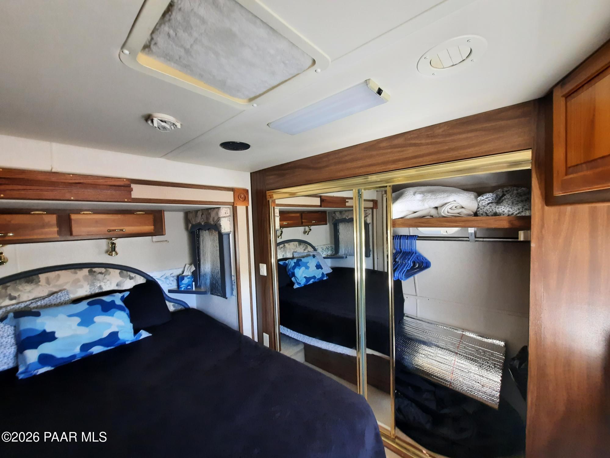 261 East W Titan Ranch Road Seligman, AZ 86337 - Photo 8 of 24 a bedroom with a bed and a mirror