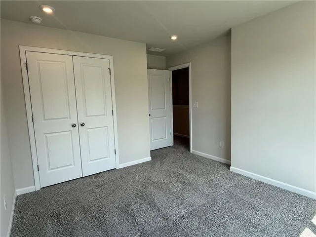a view of an empty room and closet area