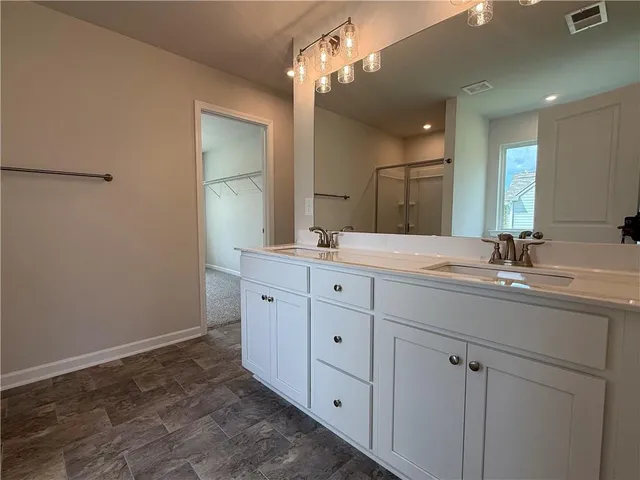 a bathroom with a double vanity sink and a mirror