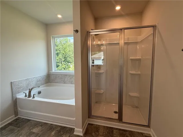 a bathroom with a bathtub and a shower