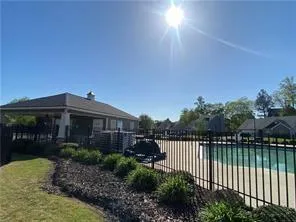 a view of a brick house with a small yard and plants