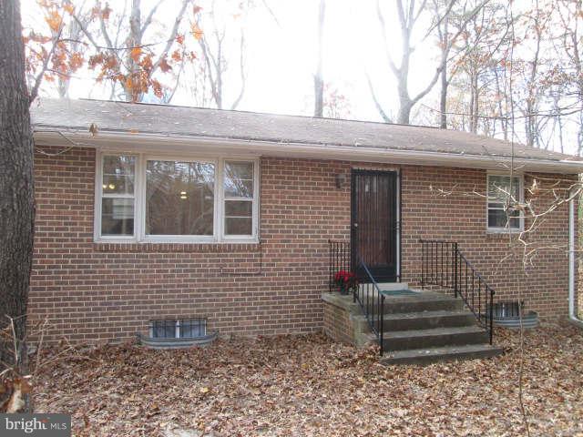 11520 H G Trueman Road Lusby, MD 20657 - Photo 1 of 1 Front of home faces wooded area. DW leads to rear.
