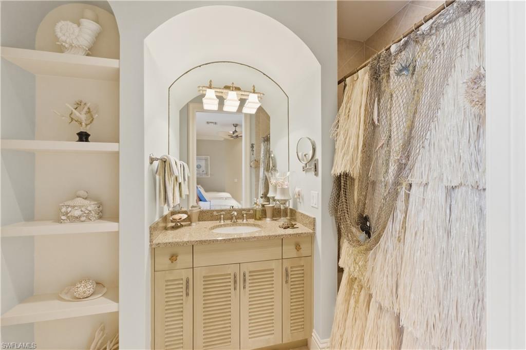 361 Pirates Bight Naples, FL 34103 - Photo 36 of 45 a bathroom with a sink a toilet and a mirror