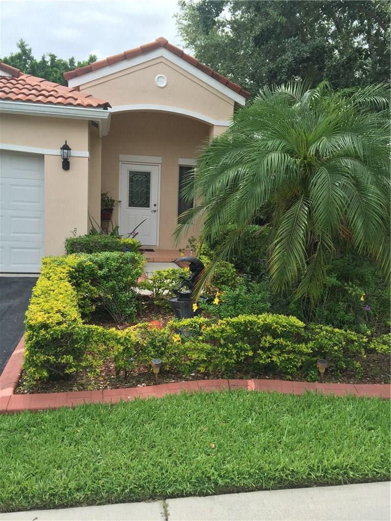 599 Talavera Road Weston, FL 33326 - Photo 3 of 17 a view of a house with a yard