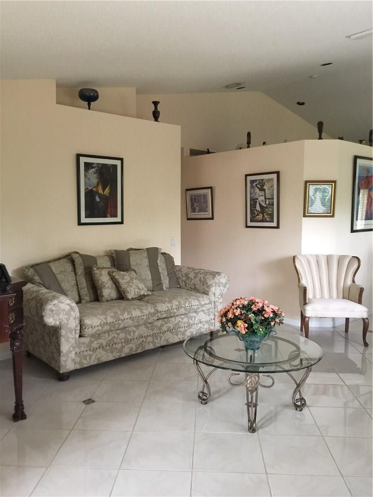 599 Talavera Road Weston, FL 33326 - Photo 7 of 17 a living room with furniture and flowers