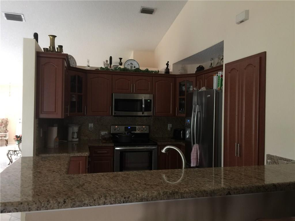 599 Talavera Road Weston, FL 33326 - Photo 10 of 17 a bathroom with a sink a mirror and cabinets
