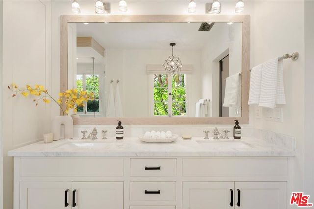 a bedroom with a bed wooden floor and window