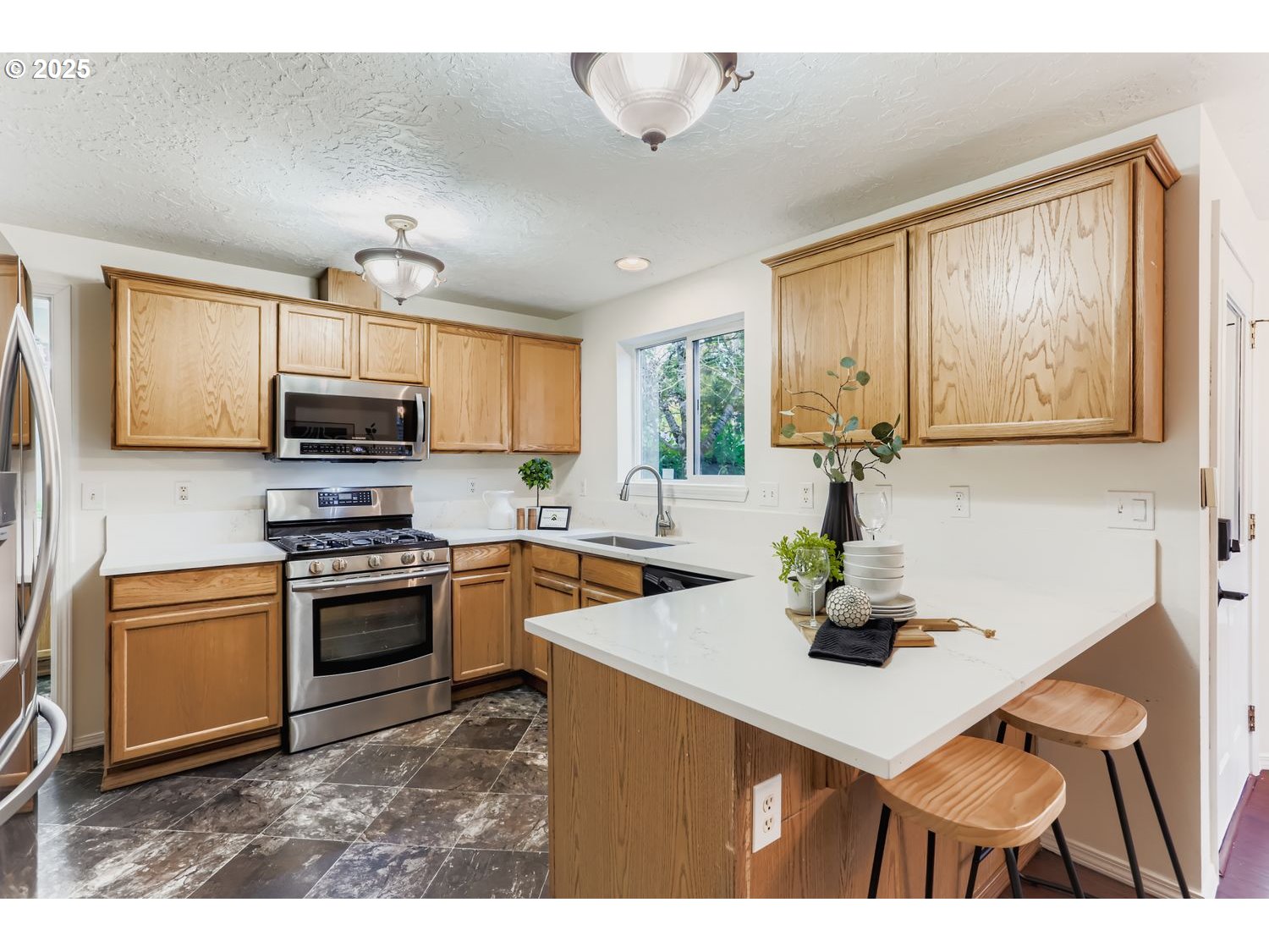 5626 North Williams Avenue Portland, OR 97217 - Photo 6 of 21 a kitchen with stainless steel appliances a sink a stove a refrigerator cabinets and dining table